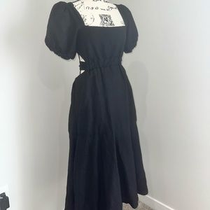 Black midi summer dress with a wrapped bodice and an open-and-tied back.